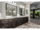 Dark cabinets with double sinks and large mirrors complement this modern style bathroom at 1725 E Everglade Ln, Gilbert, AZ 85298