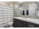 The stylish bathroom features a shower and tub combination with a dark vanity at 1725 E Everglade Ln, Gilbert, AZ 85298