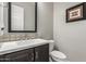 Bathroom with a black cabinet, a white countertop, a toilet, and a black-framed mirror at 1725 E Everglade Ln, Gilbert, AZ 85298