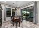 Dining room with tile floors, an ornate light fixture, a dining table, and views to the backyard at 1725 E Everglade Ln, Gilbert, AZ 85298