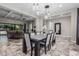 Open-concept dining room featuring pendant lighting, a coffered ceiling, and direct access to the living room at 1725 E Everglade Ln, Gilbert, AZ 85298