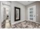 Welcoming foyer featuring a stylish front door with sidelights and a decorative mirror accentuating the neutral color palette at 1725 E Everglade Ln, Gilbert, AZ 85298