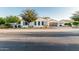 Street view of single-story home featuring desert landscaping, a paved driveway, and a three-car garage at 1725 E Everglade Ln, Gilbert, AZ 85298