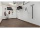 Clean garage featuring painted white walls, overhead storage, and convenient wall-mounted tool racks at 1725 E Everglade Ln, Gilbert, AZ 85298