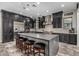 Modern kitchen with black cabinets, stainless steel appliances, and a large center island with bar stool seating at 1725 E Everglade Ln, Gilbert, AZ 85298