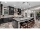 Kitchen with a center island, black cabinets, stainless steel appliances, tile floors, and bar stool seating at 1725 E Everglade Ln, Gilbert, AZ 85298