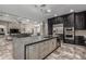 Kitchen with stainless steel appliances, a center island, light cabinets, dark cabinets, and tile floors at 1725 E Everglade Ln, Gilbert, AZ 85298