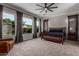 The main bedroom has a king-size bed, a sitting chair, large windows, and modern curtains at 1725 E Everglade Ln, Gilbert, AZ 85298
