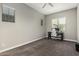 This home office features carpeted floors, a ceiling fan, and a large window at 1725 E Everglade Ln, Gilbert, AZ 85298