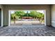 This is a view from the patio looking out to the backyard area featuring a water feature and palm trees at 1725 E Everglade Ln, Gilbert, AZ 85298