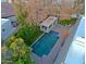 Aerial view of a backyard featuring a sparkling pool and a covered patio area, perfect for outdoor relaxation at 18 W Kaler Dr, Phoenix, AZ 85021