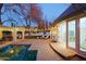 Inviting backyard pool area with a covered patio, lounge seating, and seamless access to the home's interior at 18 W Kaler Dr, Phoenix, AZ 85021