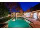 Beautiful backyard pool with outdoor dining and lounge area, perfect for entertaining guests on warm evenings at 18 W Kaler Dr, Phoenix, AZ 85021