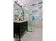 Modern bathroom features include a glass enclosed shower and vanity sink at 18 W Kaler Dr, Phoenix, AZ 85021