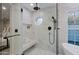 Spa bathroom featuring glass shower with bench and marble tiling at 18 W Kaler Dr, Phoenix, AZ 85021