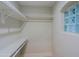 Walk-in closet features include built-in shelving and a glass block window at 18 W Kaler Dr, Phoenix, AZ 85021