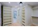 Bright walk-in closet with shelving, opening into the stunning bath at 18 W Kaler Dr, Phoenix, AZ 85021