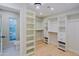 Bright and airy closet featuring extensive storage and stylish lighting at 18 W Kaler Dr, Phoenix, AZ 85021