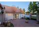 Paved courtyard with fountain, bench, potted plants, and french doors provide an inviting outdoor space at 18 W Kaler Dr, Phoenix, AZ 85021