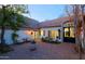 Serene brick courtyard featuring comfortable seating, lush plants, and decorative fountain at 18 W Kaler Dr, Phoenix, AZ 85021