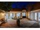 Charming courtyard with lush landscaping, outdoor seating, a fountain, and inviting ambiance at 18 W Kaler Dr, Phoenix, AZ 85021