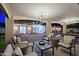 Relaxing covered patio offers ample seating, a chandelier, and a beautiful view of the pool at 18 W Kaler Dr, Phoenix, AZ 85021