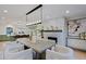 Open-concept dining area featuring stone fireplace and modern light fixture at 18 W Kaler Dr, Phoenix, AZ 85021