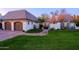 Lush front yard with manicured lawn, brick driveway, and charming architecture creates an inviting curb appeal at 18 W Kaler Dr, Phoenix, AZ 85021