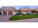 Exterior view of home featuring a lush front yard, charming architecture, and an attached garage at 18 W Kaler Dr, Phoenix, AZ 85021