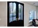 Elegant front door with decorative glass, complemented by a charming window and chair at 18 W Kaler Dr, Phoenix, AZ 85021