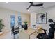 Bright home office with modern ceiling fan, a light wood desk, and backyard access at 18 W Kaler Dr, Phoenix, AZ 85021