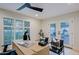 Light-filled home office featuring plantation shutters and access to the backyard patio at 18 W Kaler Dr, Phoenix, AZ 85021