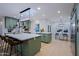Well-lit kitchen with green cabinets, white countertops, and an adjacent dining area at 18 W Kaler Dr, Phoenix, AZ 85021