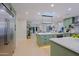 Open floor plan with green cabinets, stainless steel appliances, and lots of natural light at 18 W Kaler Dr, Phoenix, AZ 85021
