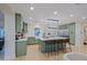 Spacious green kitchen with eat-in island, white countertops, and ample cabinet space at 18 W Kaler Dr, Phoenix, AZ 85021