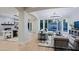 Open-concept design with modern lighting, spacious seating, and views of the outdoor pool area at 18 W Kaler Dr, Phoenix, AZ 85021