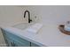 Modern sink with matte black faucet, white countertops, and decorative backsplash tiles at 18 W Kaler Dr, Phoenix, AZ 85021