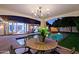 Outdoor covered patio with a dining table that overlooks the refreshing backyard pool at 18 W Kaler Dr, Phoenix, AZ 85021