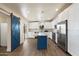 Modern kitchen with white cabinets, stainless steel appliances, and a stylish blue island at 1939 E Alameda Dr, Tempe, AZ 85282