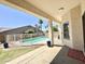 Covered back patio showcasing an enclosed swimming pool and lush landscaping creating an outdoor oasis at 20906 N 56Th Dr, Glendale, AZ 85308