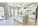 Beautiful kitchen with granite island, sleek white cabinets, and stainless steel appliances at 20906 N 56Th Dr, Glendale, AZ 85308