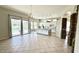 Open kitchen and living area, showcasing a granite island, white cabinets, and pool access at 20906 N 56Th Dr, Glendale, AZ 85308