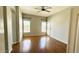 Spacious room with hardwood floors, ceiling fan, and lots of natural light from windows and a glass patio door at 20906 N 56Th Dr, Glendale, AZ 85308