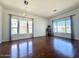 Bright and airy living room with gleaming wood floors and large windows at 20906 N 56Th Dr, Glendale, AZ 85308