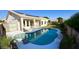 Inviting backyard pool features a clean white deck and lush tropical landscaping, perfect for relaxing and entertaining at 20906 N 56Th Dr, Glendale, AZ 85308