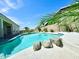 Sparkling swimming pool with rock accents in a well-maintained backyard with lush greenery, ideal for outdoor fun at 20906 N 56Th Dr, Glendale, AZ 85308