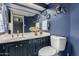 Modern bathroom with blue walls, a single sink vanity, framed mirrors, and modern fixtures at 2121 W Union Hills Dr # 113, Phoenix, AZ 85027
