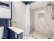 Contemporary bathroom showcasing a marble shower and modern shelving for convenient storage at 2121 W Union Hills Dr # 113, Phoenix, AZ 85027