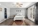 Bright bedroom featuring wood floors, a ceiling fan, and access to an outdoor patio at 2121 W Union Hills Dr # 113, Phoenix, AZ 85027