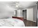 Bedroom features a ceiling fan, closet, gray walls and wood floors at 2121 W Union Hills Dr # 113, Phoenix, AZ 85027